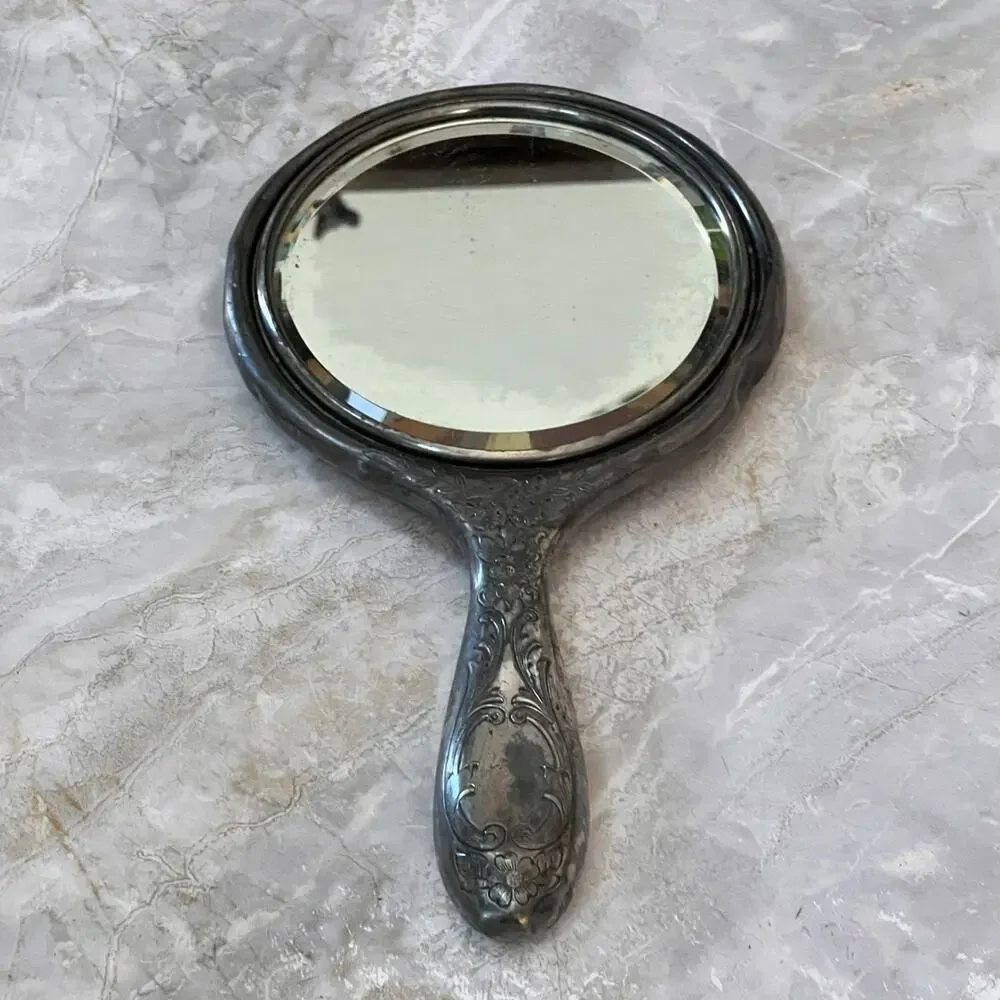 Silver Plated Hand Held Mirror with Intricate Raised Floral Scrollwork